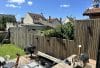 Clôture bois installée autour d'une terrasse, avec mobilier de jardin